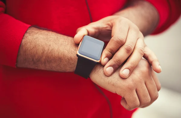 Hands of African male using trendy smart watch