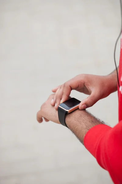 Hands of African male using smart wrist watch