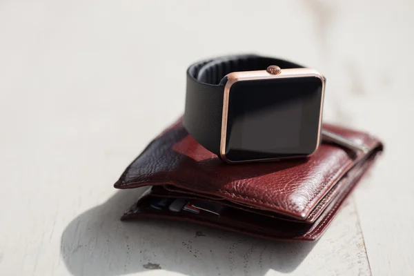Smart watches, keys and brown leather wallet