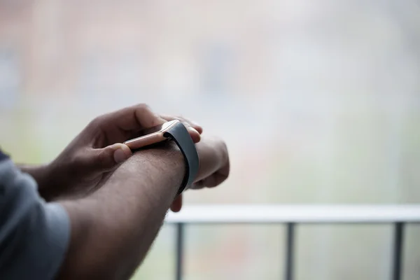 Hands of black man using modern smart wrist watch