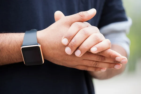 Hand of black man wearing modern smart wrist watches