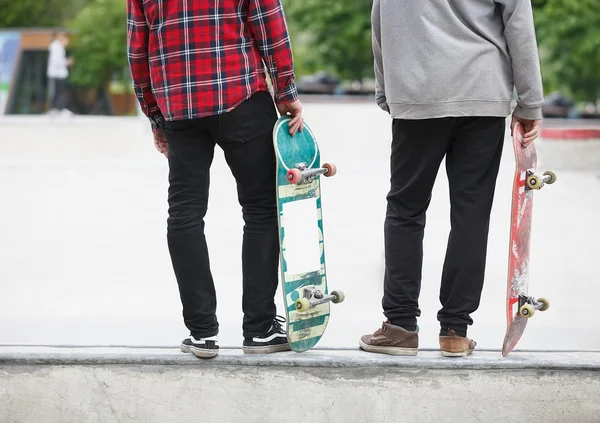 Skater boys standing on a ramp in skate park
