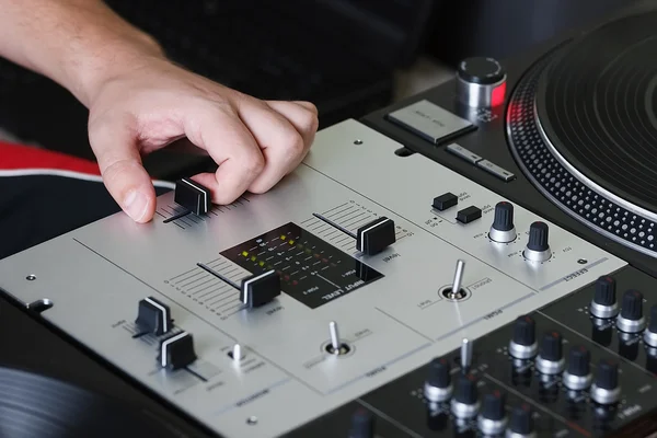 DJ mixing music on professional sound mixer