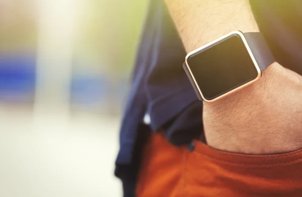 Hand of black man wearing modern smart wrist watches