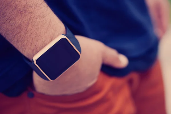 Hand of black man wearing modern smart wrist watches