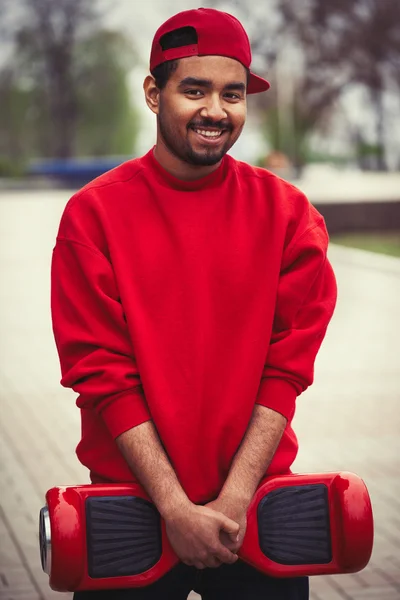 Young black boy with electric mini segway hover board scooter