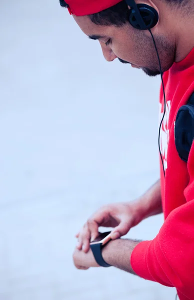 Young black guy using smart wrist watch