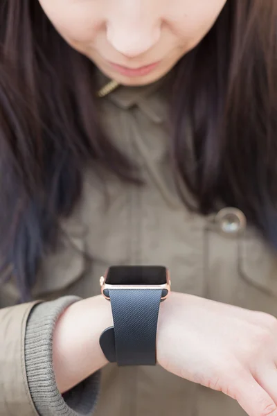 Young girl looking at her smart watch
