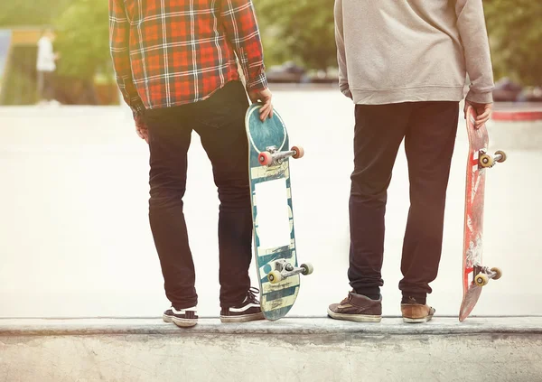 Skater boys standing on a ramp in skate park