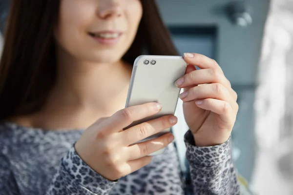 Cute white girl using modern dual camera smart phone