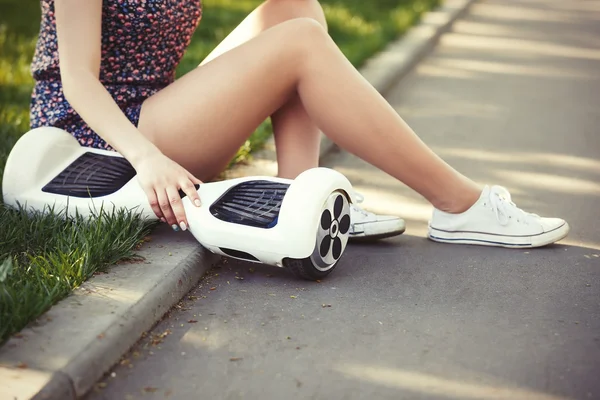 Girl with electric mini hover board scooter transport