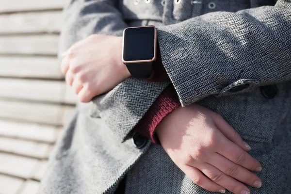 Female wearing modern smart watch on her hand