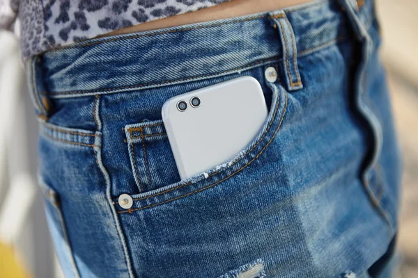 Modern dual camera smart phone in jeans pocket