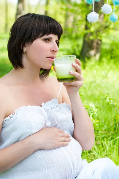 Pregnant Happy Woman drinking Milk. Mom Expecting Baby. Pregnant