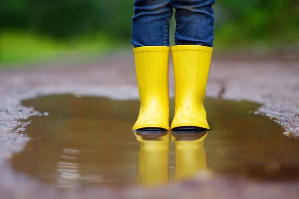 Child wearing rain boots