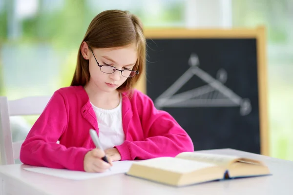 Smart little schoolgirl writing test