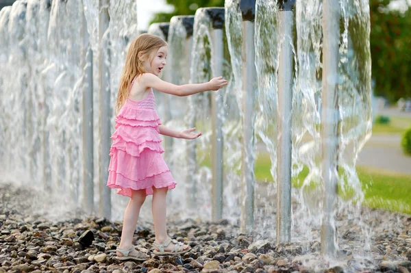 Girl playing with fountain