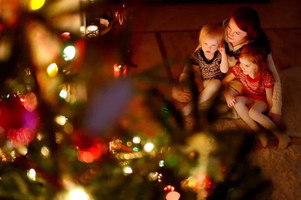 Mother and daughters near fireplace