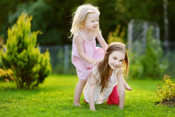Sisters having fun on the grass