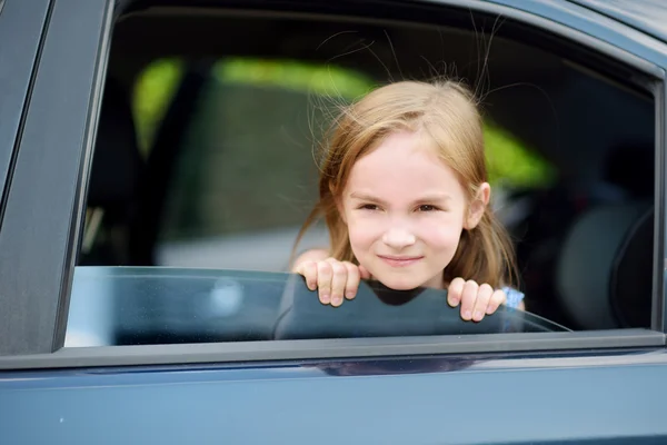 Girl  sticking her head out the car