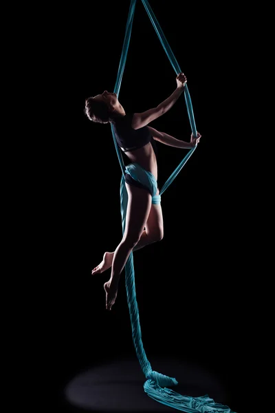 Young woman gymnast with blue gymnastic ribbon