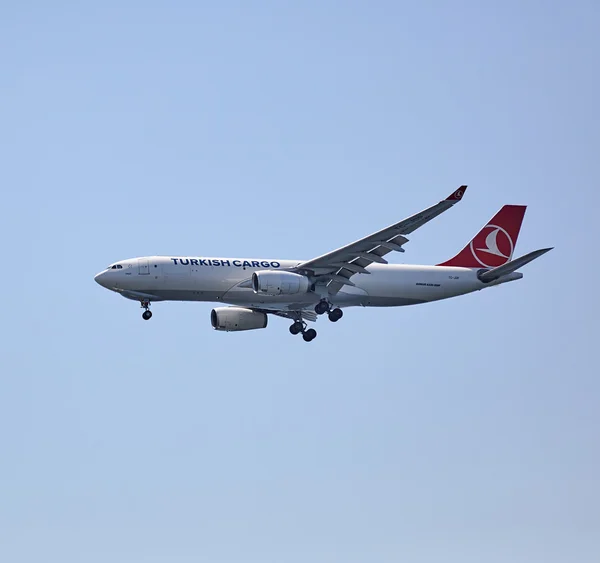 The cargo plane of Turkish Airlines flying in the sky.