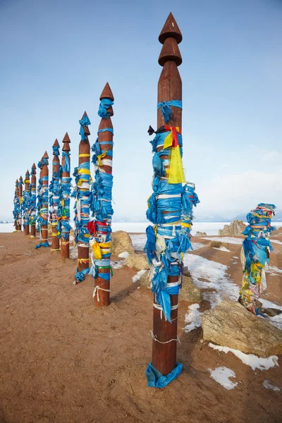 Wooden shaman totems with ribbons