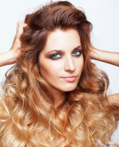 Portrait of young beautiful woman with curly shaggy hair style