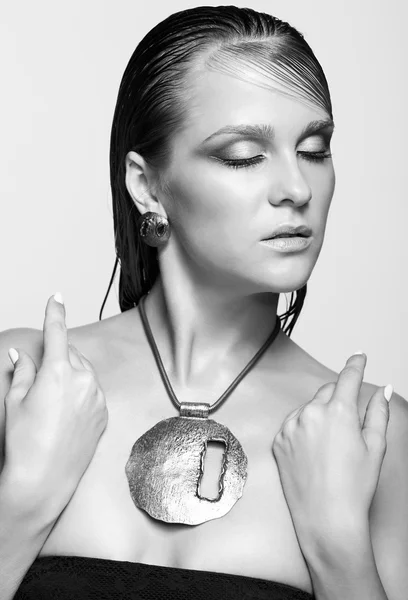 Woman with wet shining  makeup and closed eyes