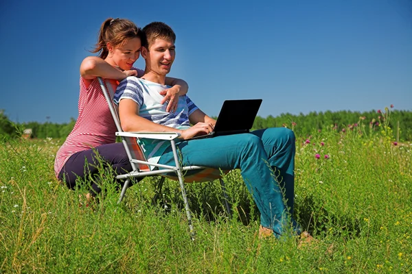 Couple on the nature watching in a laptop