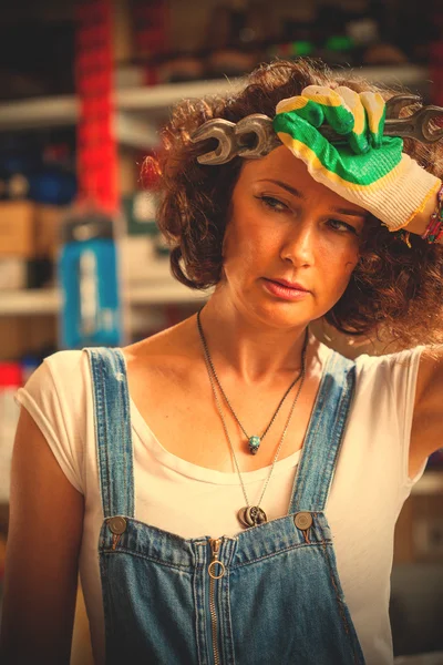 Portrait of a auto mechanic woman wiping the face