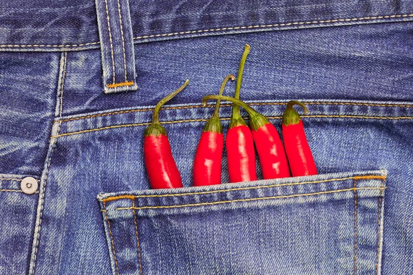 Red peppers in a jeans pocket