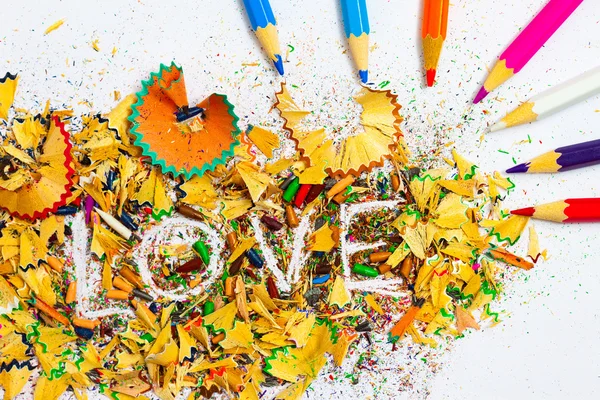 The word LOVE on the background pencil shavings