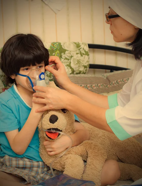 Children\'s physician spends boy inhalation session