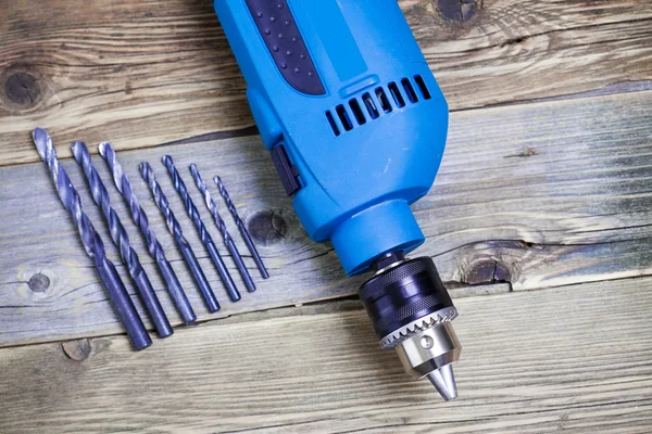 Electric drill with a set of drill bits