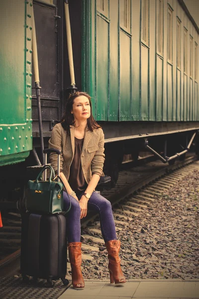 Beautiful middle-aged woman traveling in a retro style