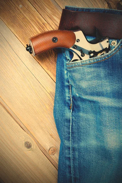 Revolver nagant in the pocket of old blue jeans