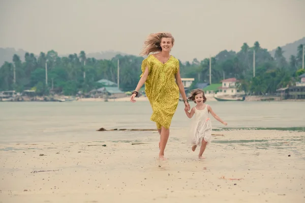 Mother and daughter are running barefoot