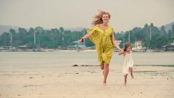 Mother and daughter are running barefoot