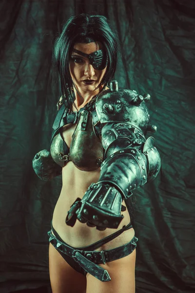 Powerful one-eyed steam punk woman in metal lingerie.