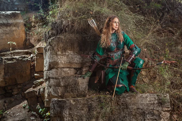 Elf woman in green leather armor with the bow