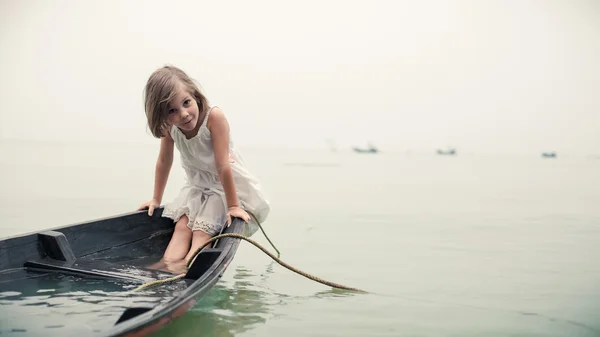 Beautiful young girl in the sinking boat.