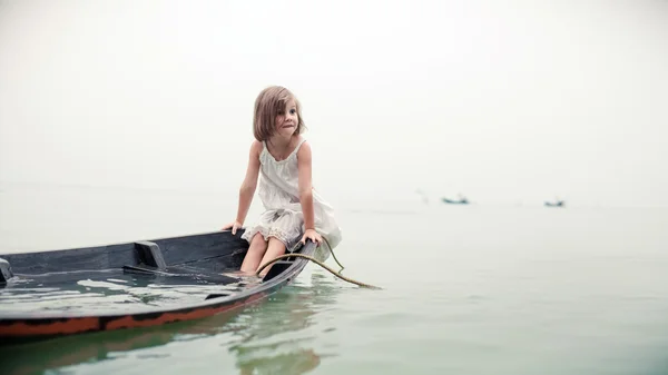 Beautiful young girl in the sinking boat.