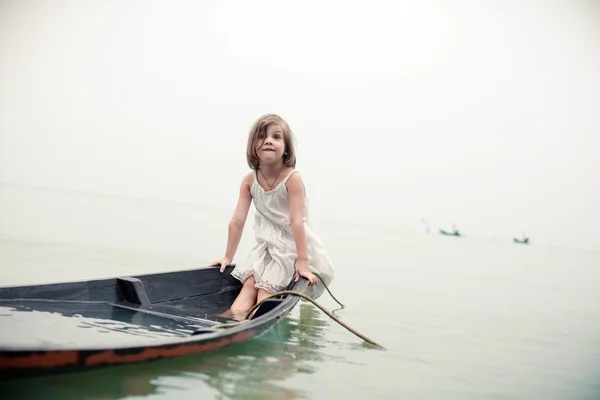 Beautiful young girl in the sinking boat.