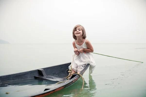 Beautiful young girl in the sinking boat.