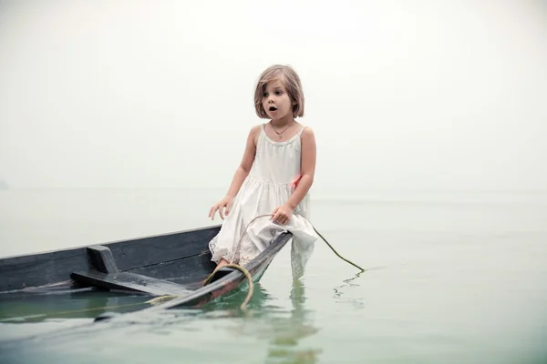 Beautiful young girl in the sinking boat.