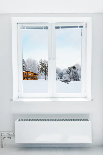 House in winter seen through the window