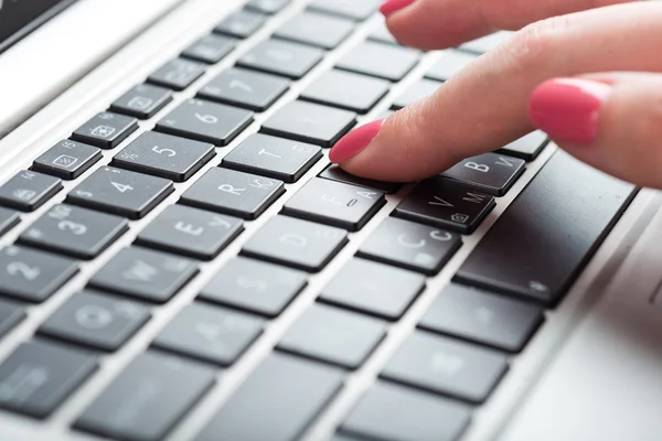 Female fingers typing on keyboard
