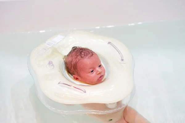 Baby swimming with neck swim ring