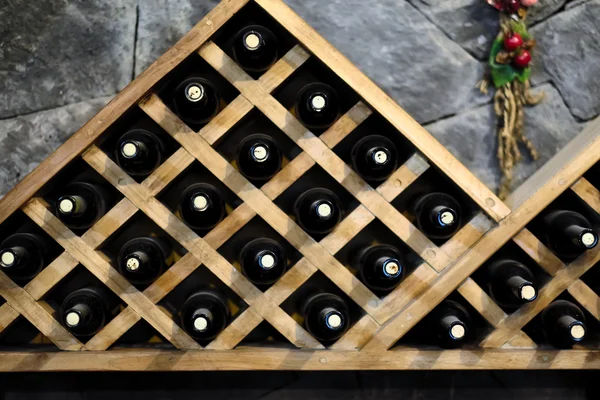 Wine bottles stacked on wooden racks